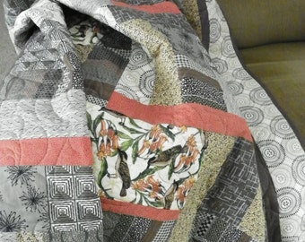 Catbirds in a geometric lap quilt