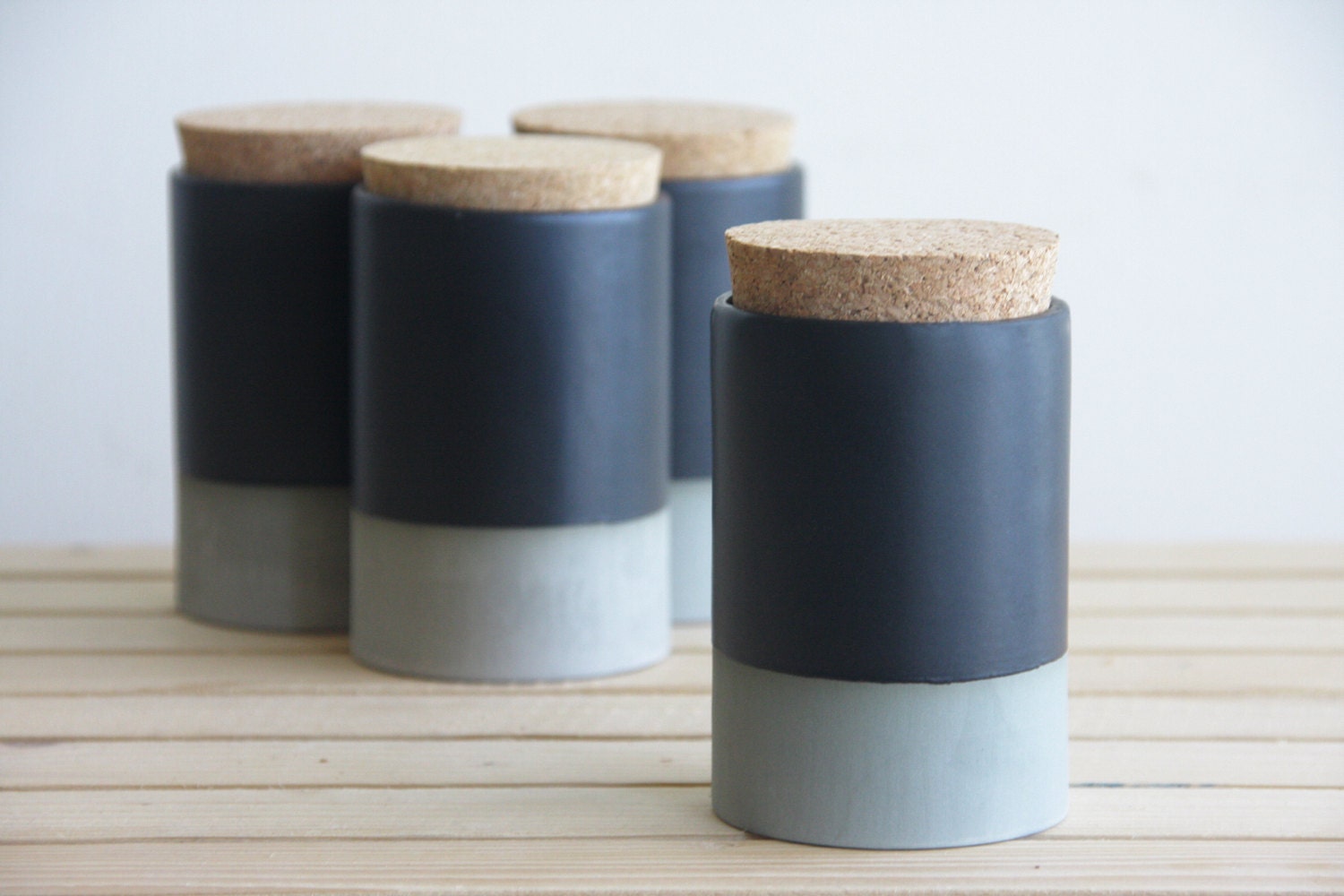 Small ceramic jar with cork lid in gray with black matte