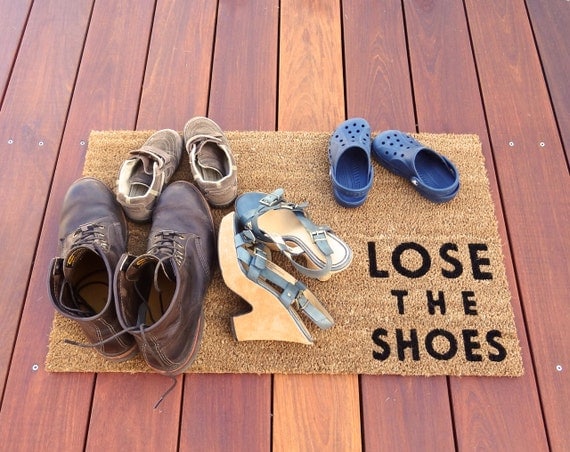 Lose the Shoes doormat lets your guests know to by Dichotomat