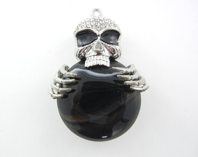 Silver-tone Dimensional Skull Holding Acrylic Black Marble Disk Pendant