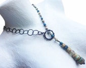 Pūjā . Rustic assemblage graduated bead pendant drop lariat necklace.
