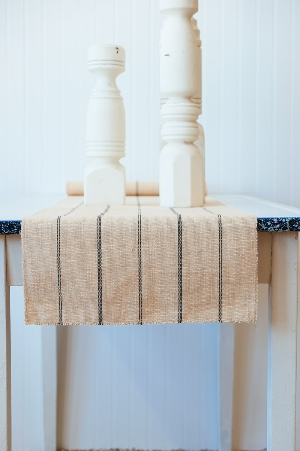 Table runner made from woven tan fabric with navy blue