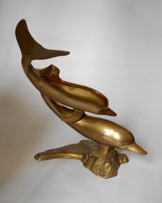 large brass dolphin statue