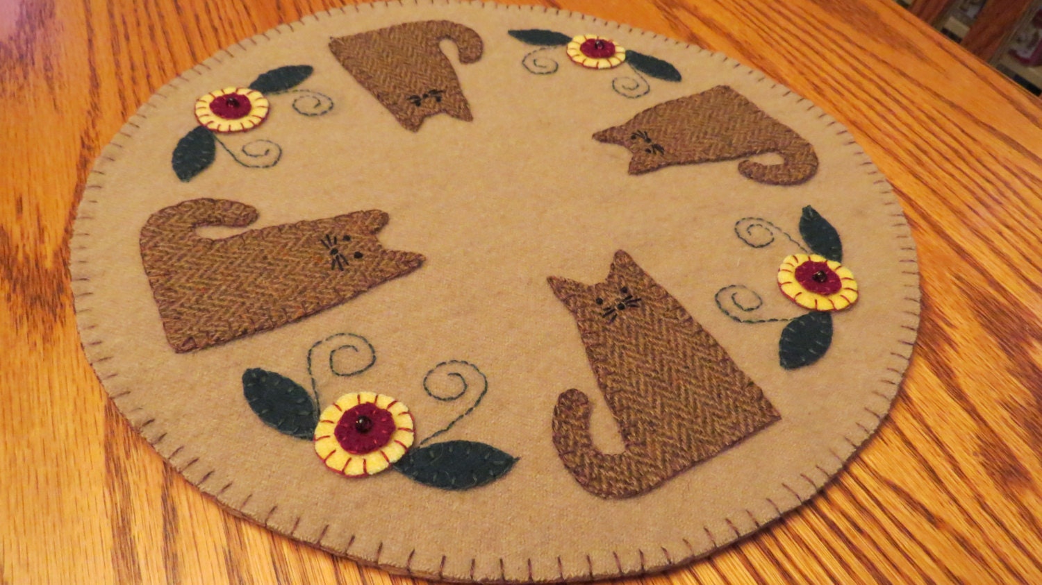 Felted wool Penny Rug Candle Mat designed for the cat lover.