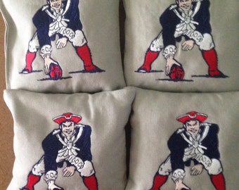 8 New England Patriots embroidered corn hole bags. Regulation size and weight. Duck cloth filled with whole corn. Double stitched.