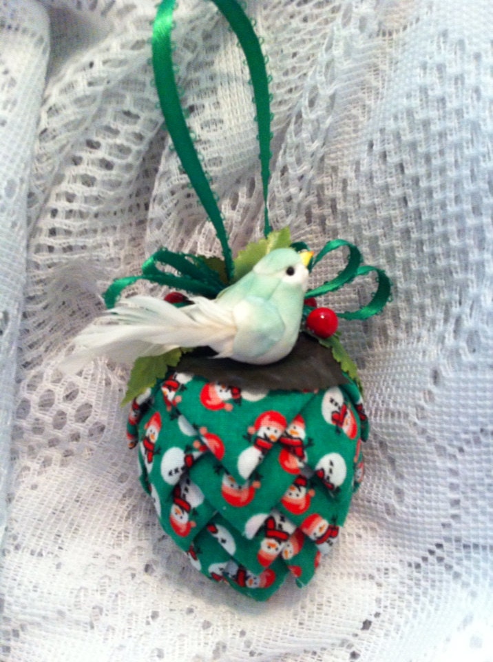 Green snowman print fabric pinecone decoration.