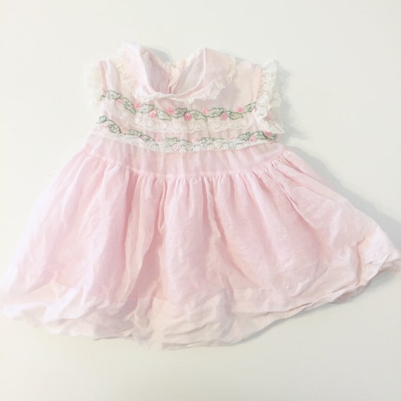 Vintage delicate pink party baby dress with lace trim and leaf petals