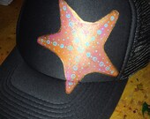 Slate grey trucker with hand painted goldy/sunset starfish. Turquoise detail.