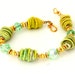 Kiwi Green Fiber Bead Bracelet. Handwrapped Artisan Fiber Beads. Gold Bali Beads. Swarovski Crystals. Beaded Bracelet.