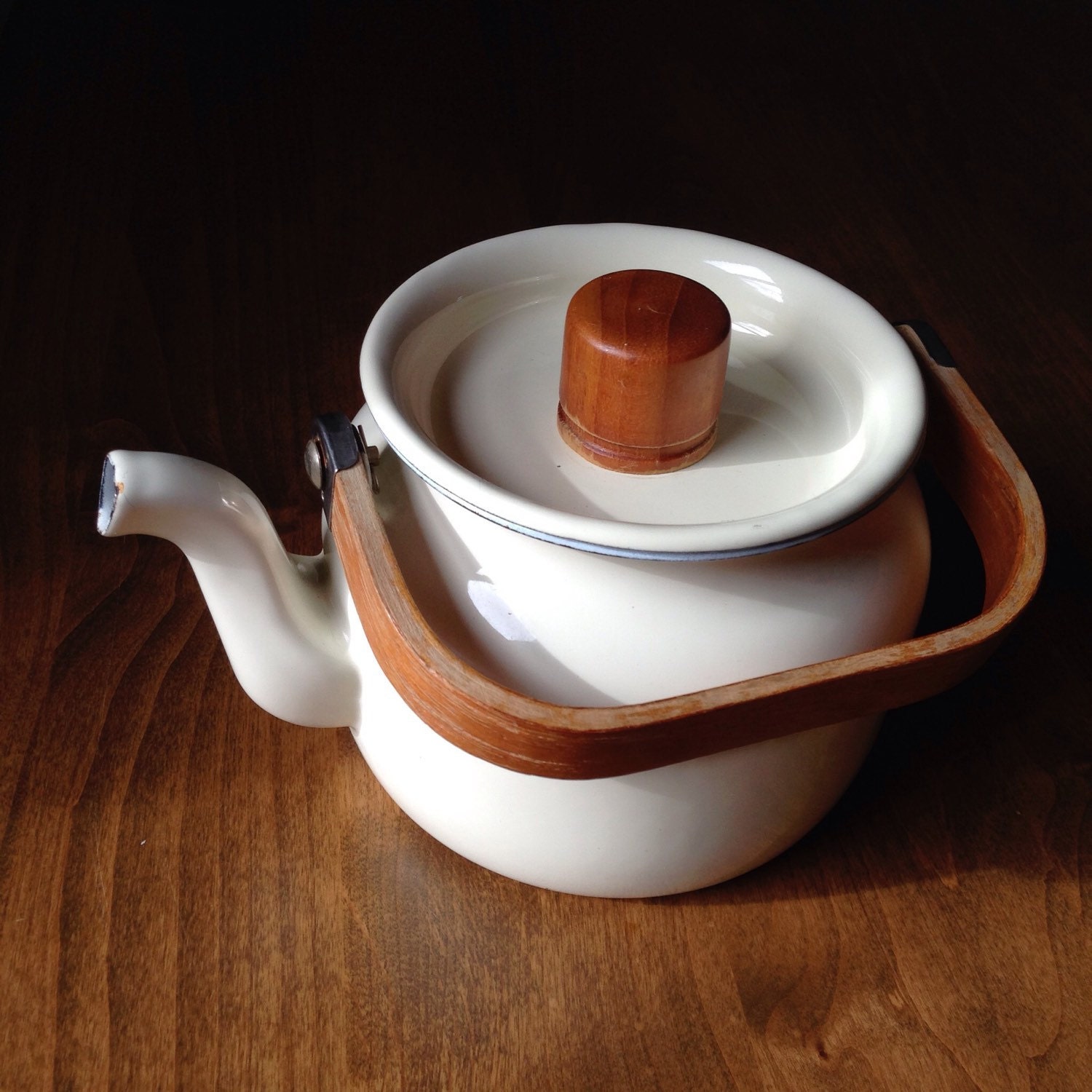 Enamelware cream color teapot with wooden handle. Haute Juice