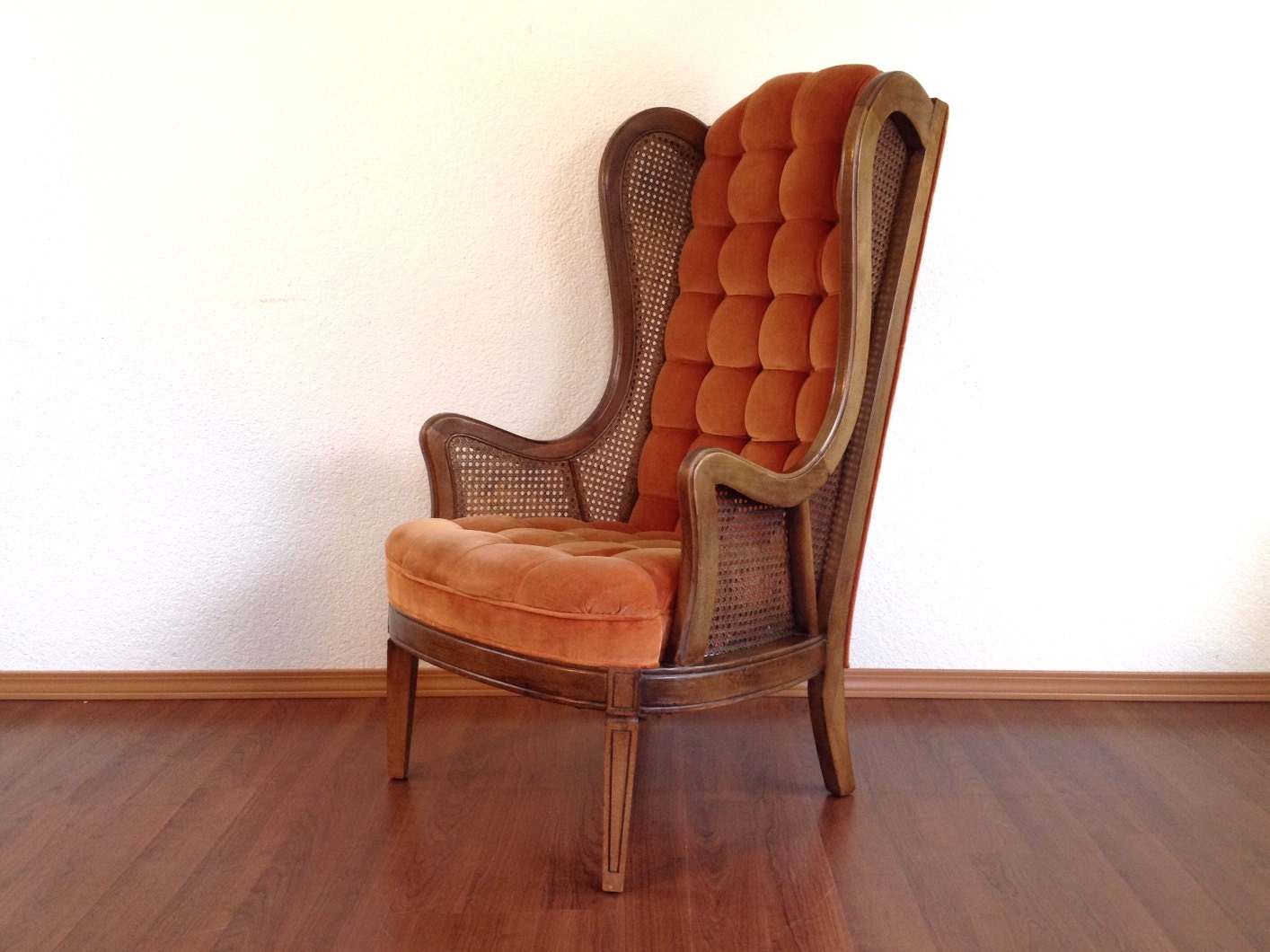 vintage cane wingback chair with tufted back & seat. by