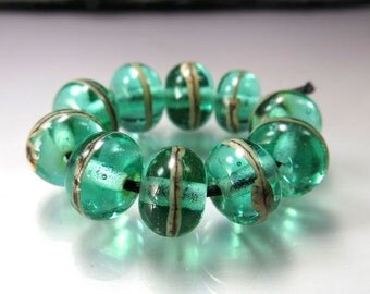 Handmade Lampwork Beads by GlassBeadArt ... Silvered Ivory over transparent green ... SRA F12 ...9x11mm