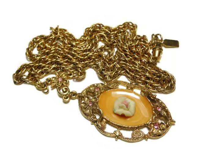 1928 necklace, butterscotch orange swirled enamel encloses standard 1928 pink porcelain rose, gold floral frame of pink rhinestone flowers