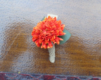 Ring bearer boutonniere designed with a orange mum