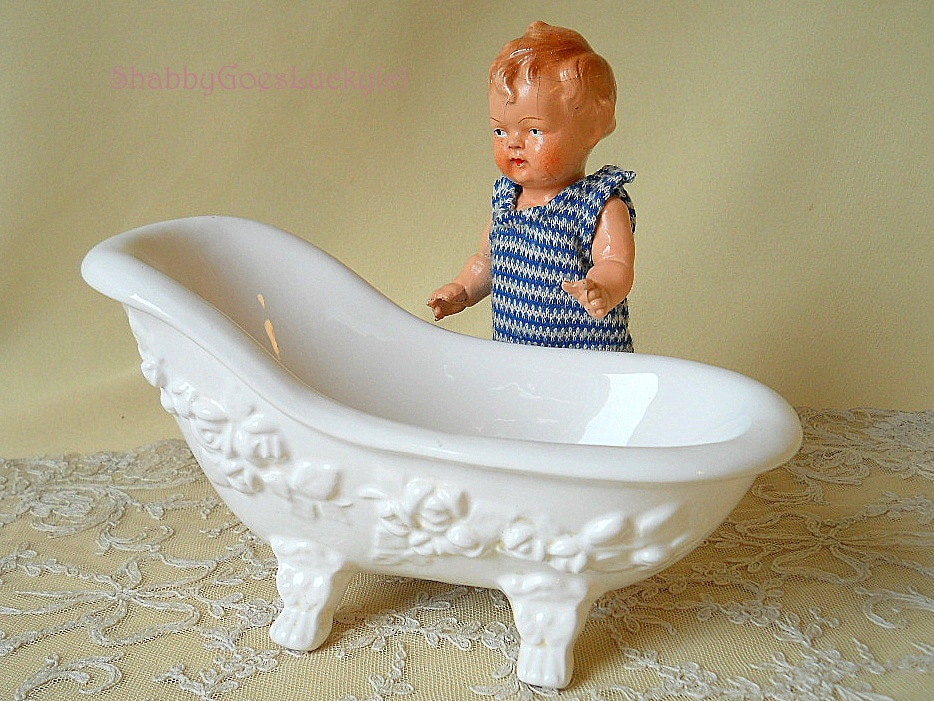 Old dollhouse bathtub, made of white porcelain china with molded rose