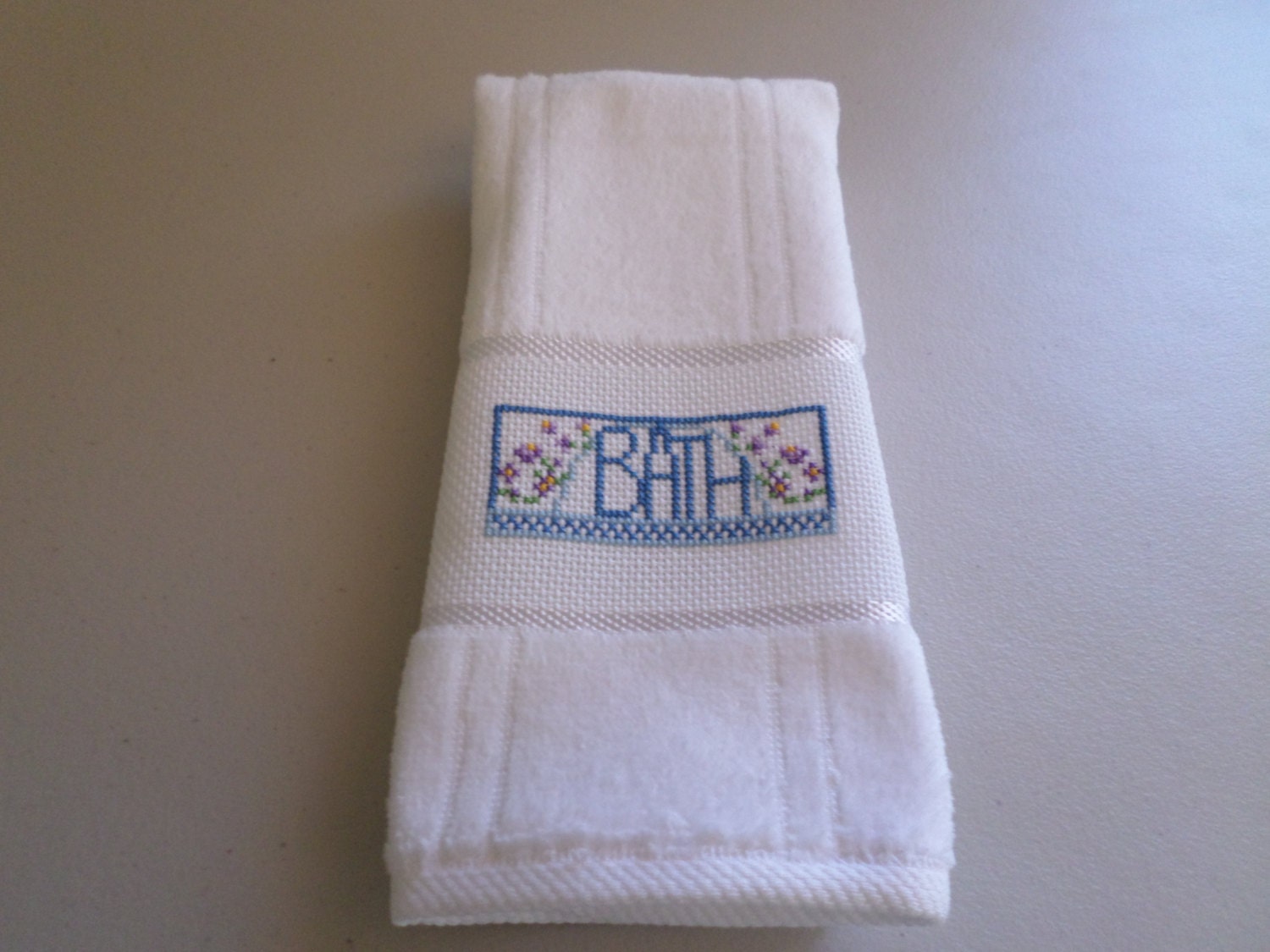 White Velour Fingertip Towel with the wording BATH
