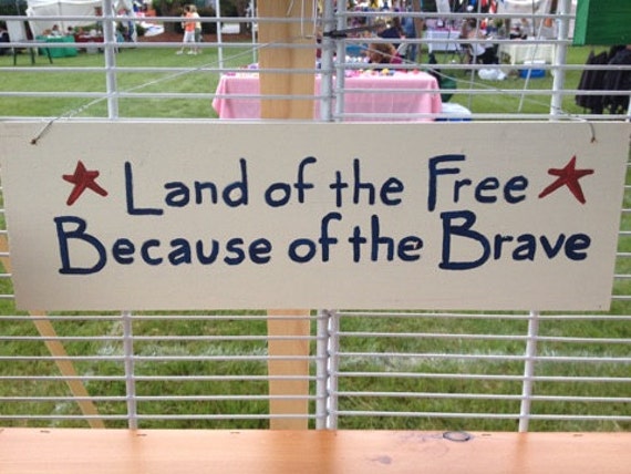 big rustic land of the free because of the brave sign