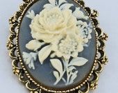 Gerry's Creations Cameo Pin or Pendant, white rose design on soft blue Gerry's Creations Cameo Pin or Pendant, white rose design on soft blue