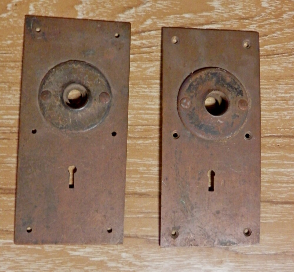 pair of vintage copper door plates with cast iron rosette