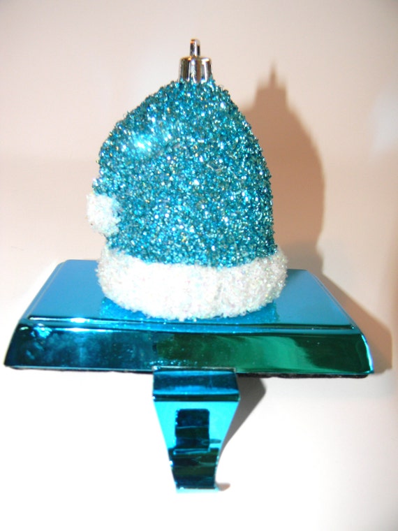 teal glitter santa cap on metallic teal stocking holder teal glitter santa cap on metallic teal stocking holder