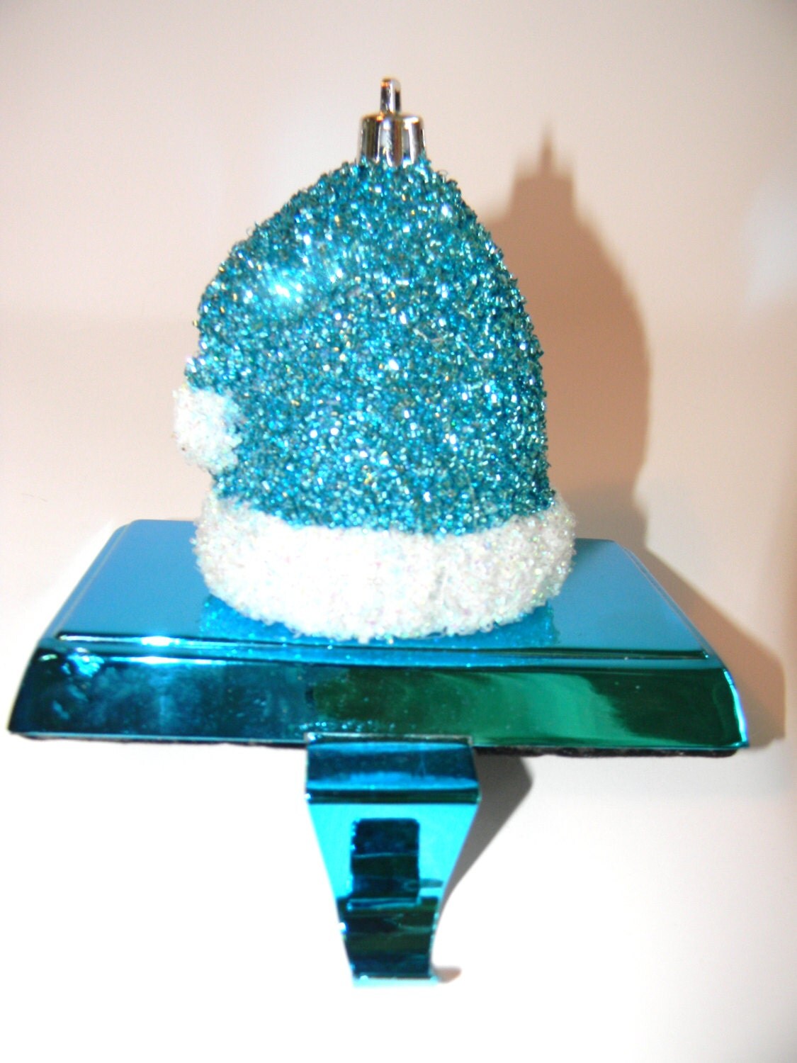 teal glitter santa cap on metallic teal stocking holder teal glitter santa cap on metallic teal stocking holder