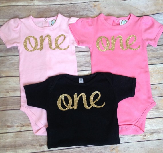 pink, gold, and black one first birthday bodysuit