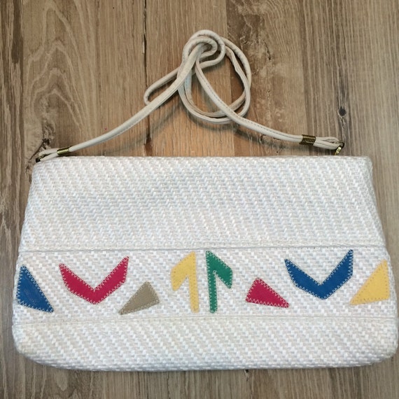 White woven shoulder strap purse with bright colored geometric