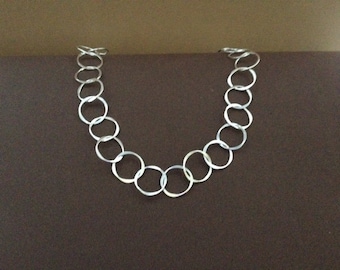 Sterling silver necklace of small 5/8th" forged circles.