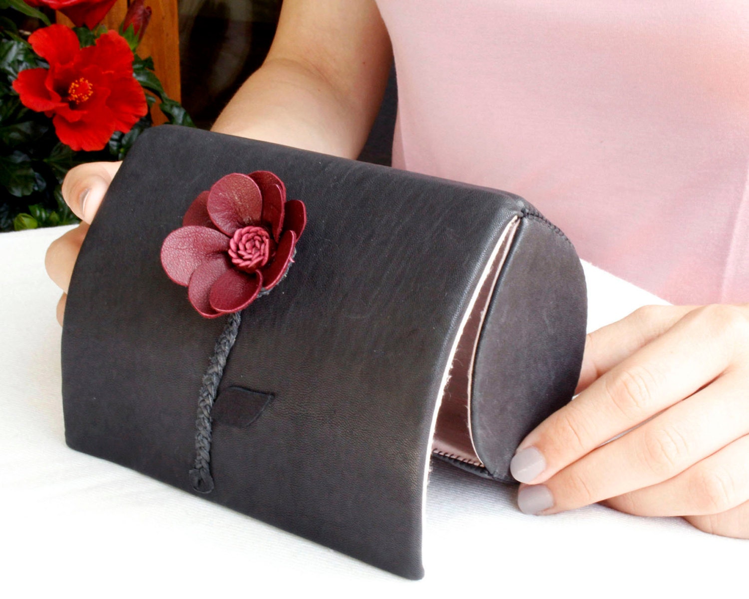 burgundy and black clutch bag