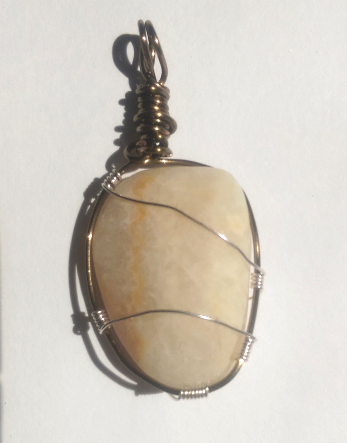 Cream colored beach stone pendant by KBDesignsJewelry on Etsy