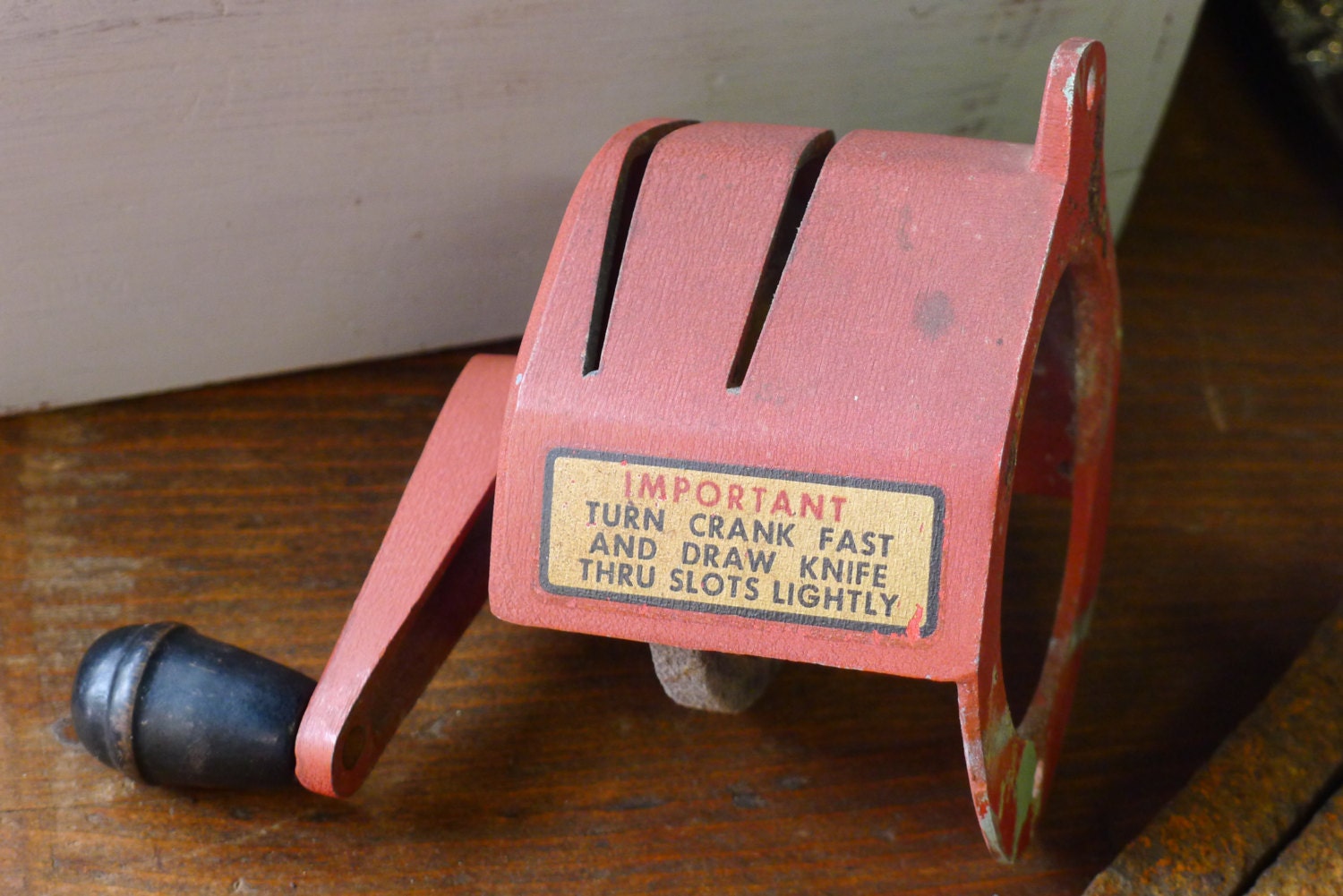 Wall mounted knife sharpener with grinding stone