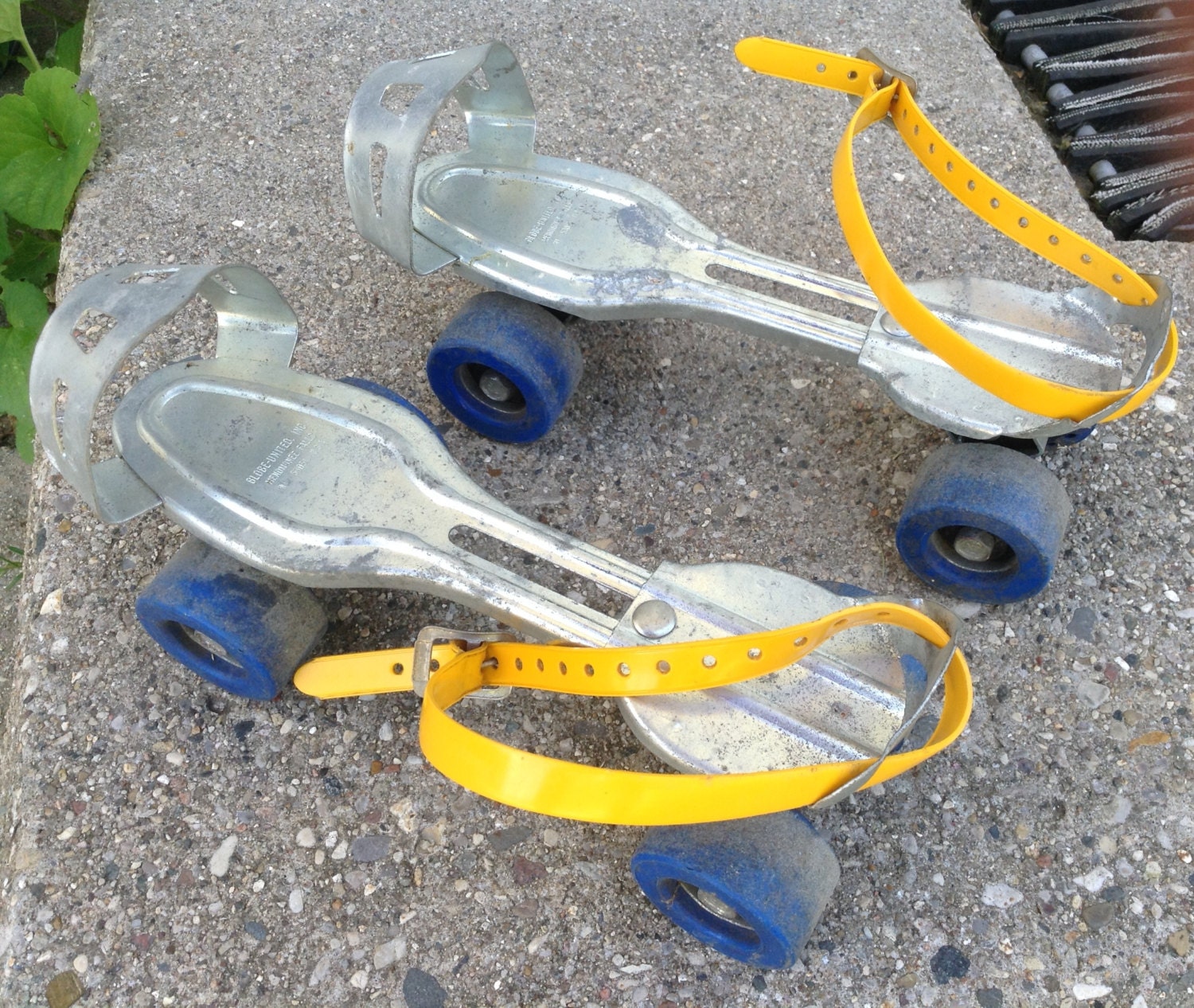 Pair of Vintage Metal Adjustable Roller Skates yellow straps