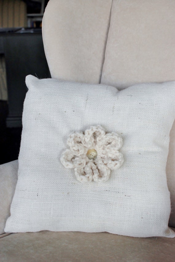 Cream colored burlap throw pillow with by