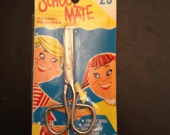 1960’s dime store school mate safety scissors with neat graphics on package.