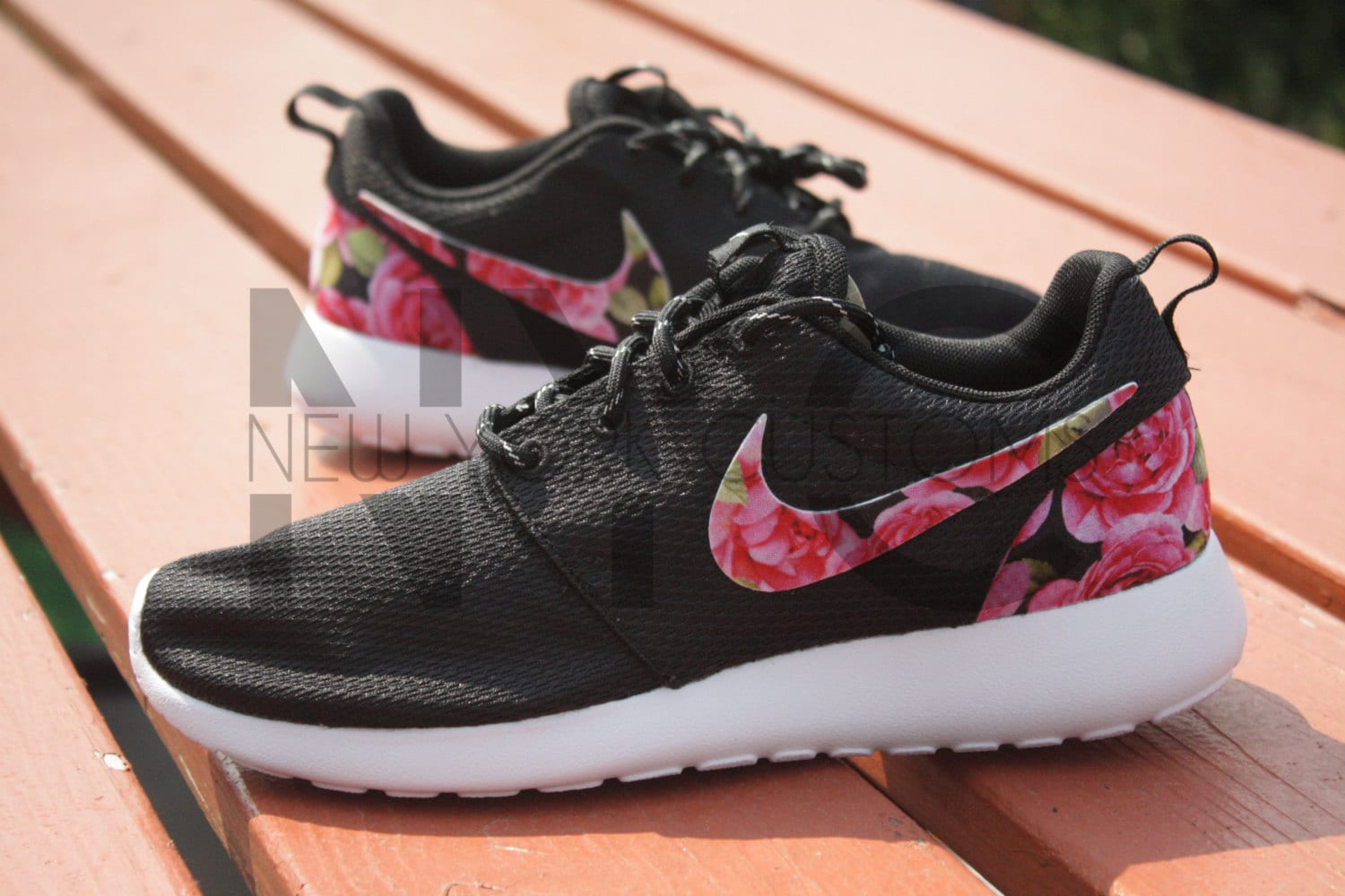 black nike shoes with flowers