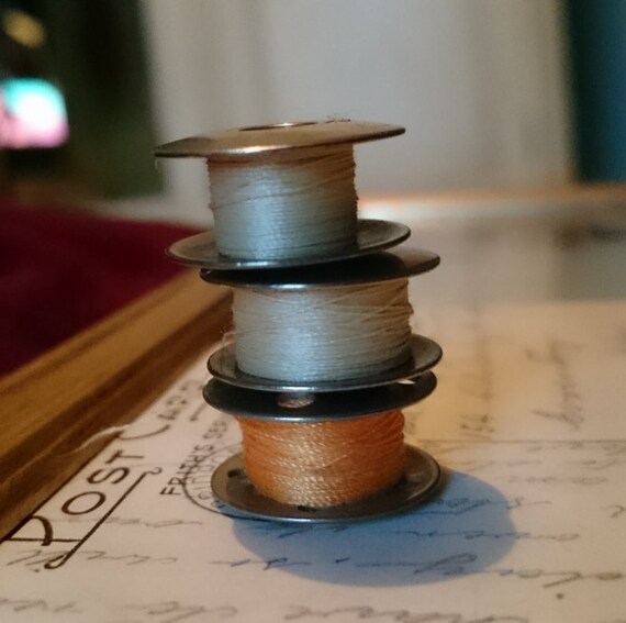 Old singer sewing machine bobbins and by curiositiesofasecond
