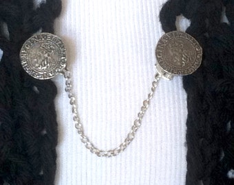 The mattie pewter Elizabethan coin sweater clip adds a touch of historical elegance to your wardrobe.