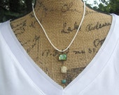 Retro Vintage Style Whimsical Green Butterfly, Flower, and Stone Pendant Necklace on White Suede