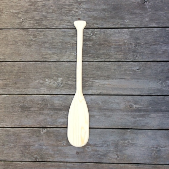 unpainted miniature wooden canoe paddles. by