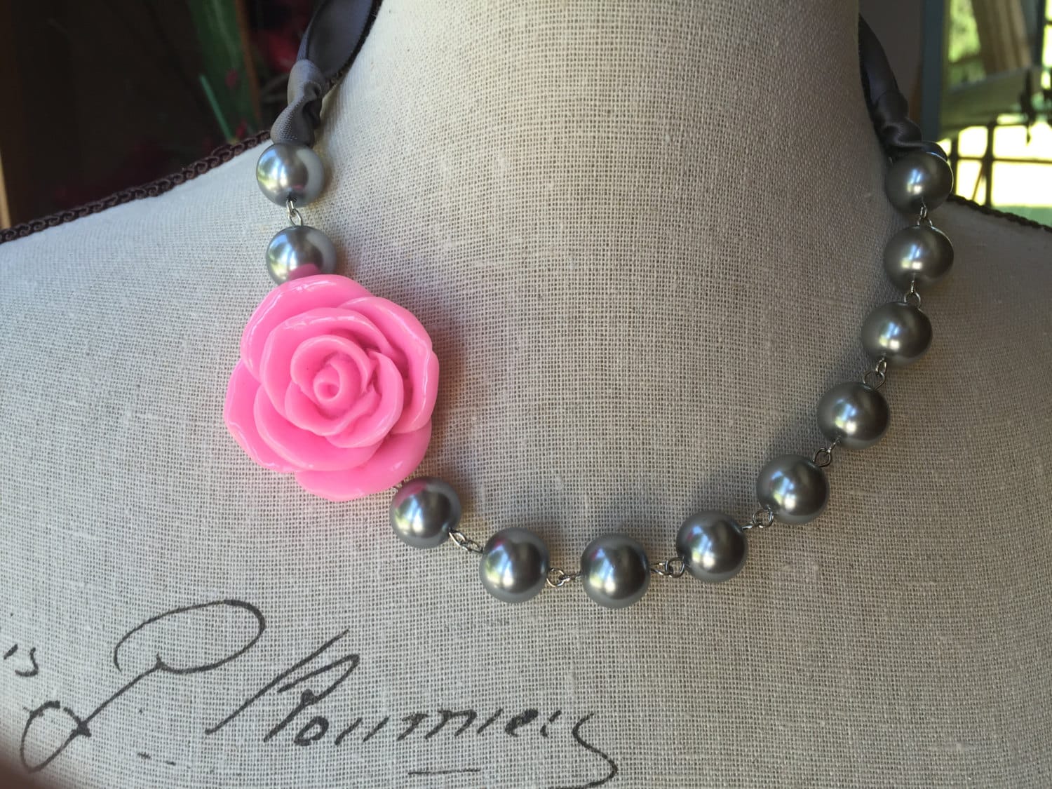 Pink flower and pewter pearls together in this Pearl necklace