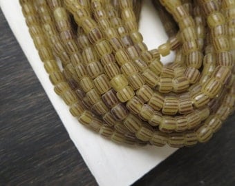 small matte striped seed beads ,yellowish grey glass beads ,Irregular barrel tube , New Indo-pacific 3 to 6mm / 10 inch strand ,3BBGL7-22