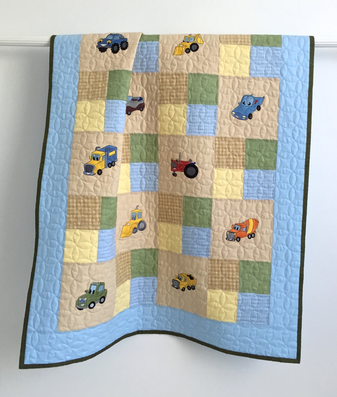 toddler-quilt-featuring-colorful-embroidered-cars-trucks