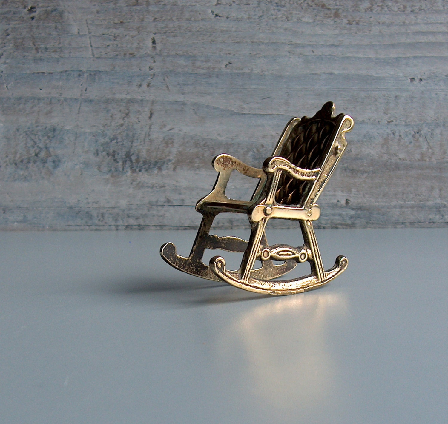 Miniature brass rocking chair. Small cast model of an old porch chair ...