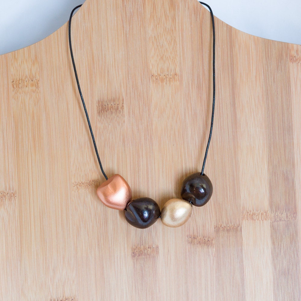 Organic seed pod necklace in copper and gold by CherryCherryBoom