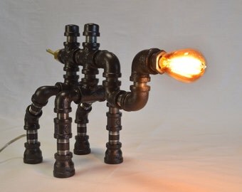 Powerful Camelamp takes Diesel Punk to the desert. Is he part locomotive? His stylized galvanized body will lead you to your inner oasis.