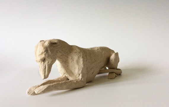 white ceramic greyhound statue