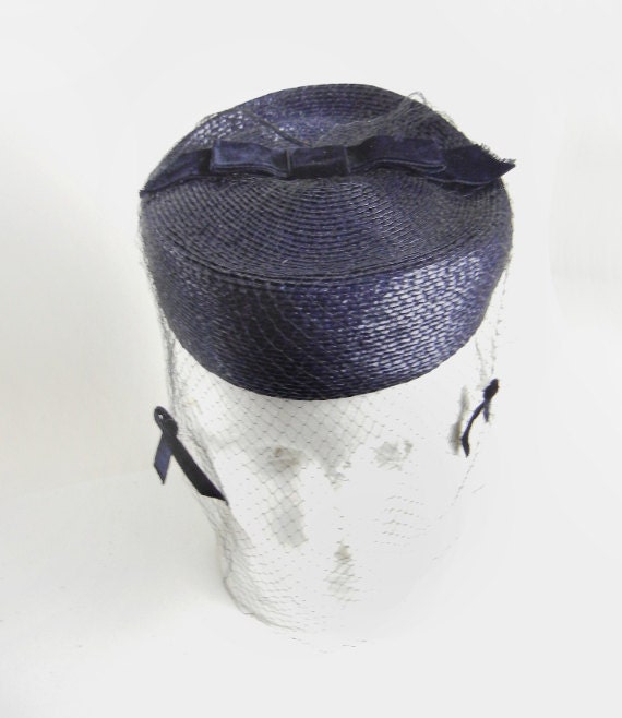 Navy blue straw pillbox hat with veil and velvet bows from