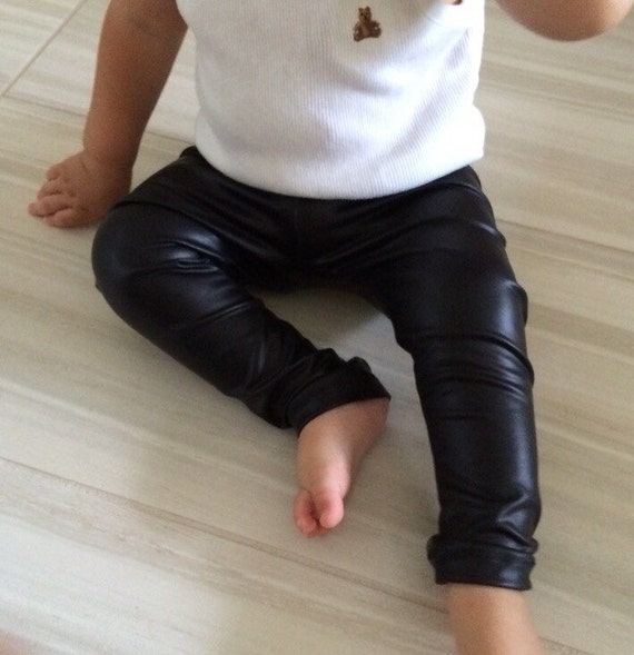 Baby Girl with Long Hair in Black Leather Jacket and Leggings is Standing  in the Studio on Grey Background Stock Photo - Image of baby, fashion:  174824226