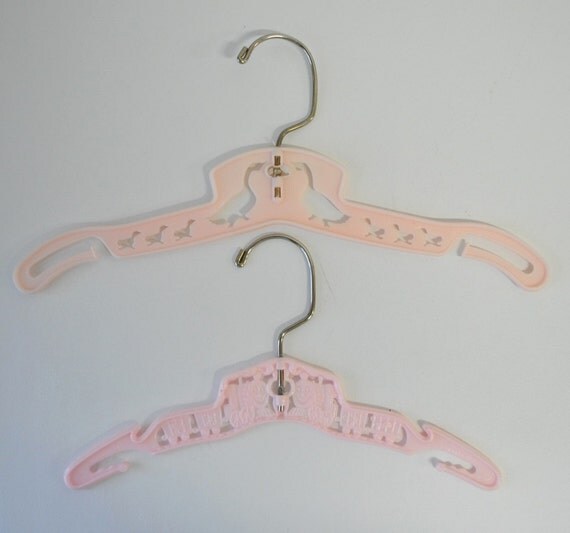 two 1950s vintage pink baby clothes hangers