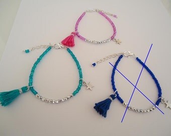 Thin beaded bracelet with a silvery star and a tassel